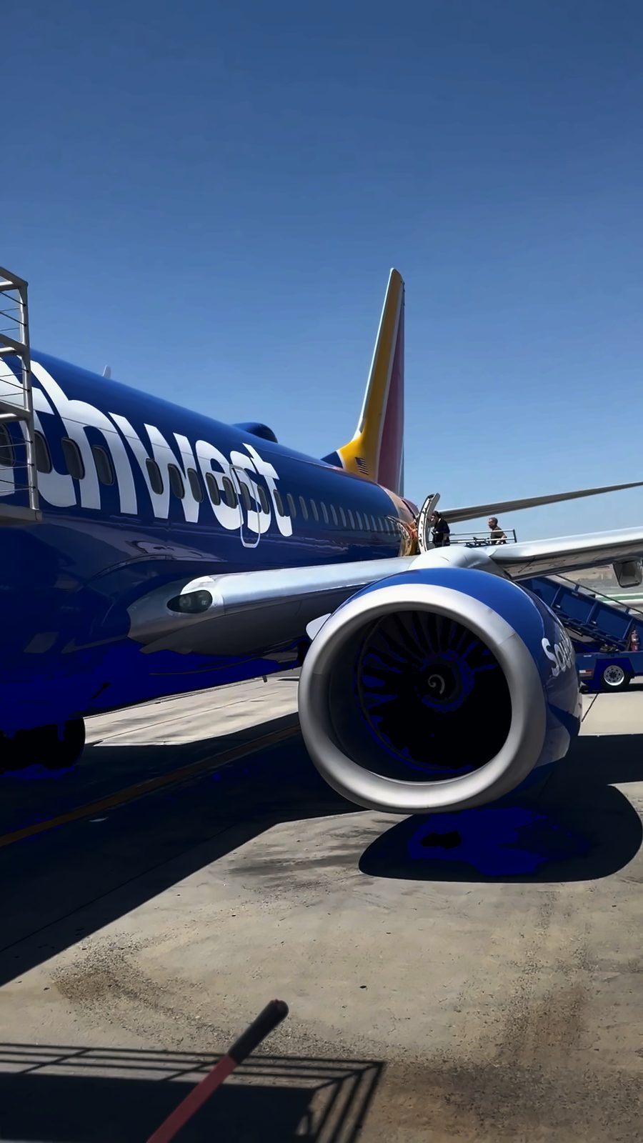 A Southwest Airlines jet on the tarmac at Burbank airport under a blue sky