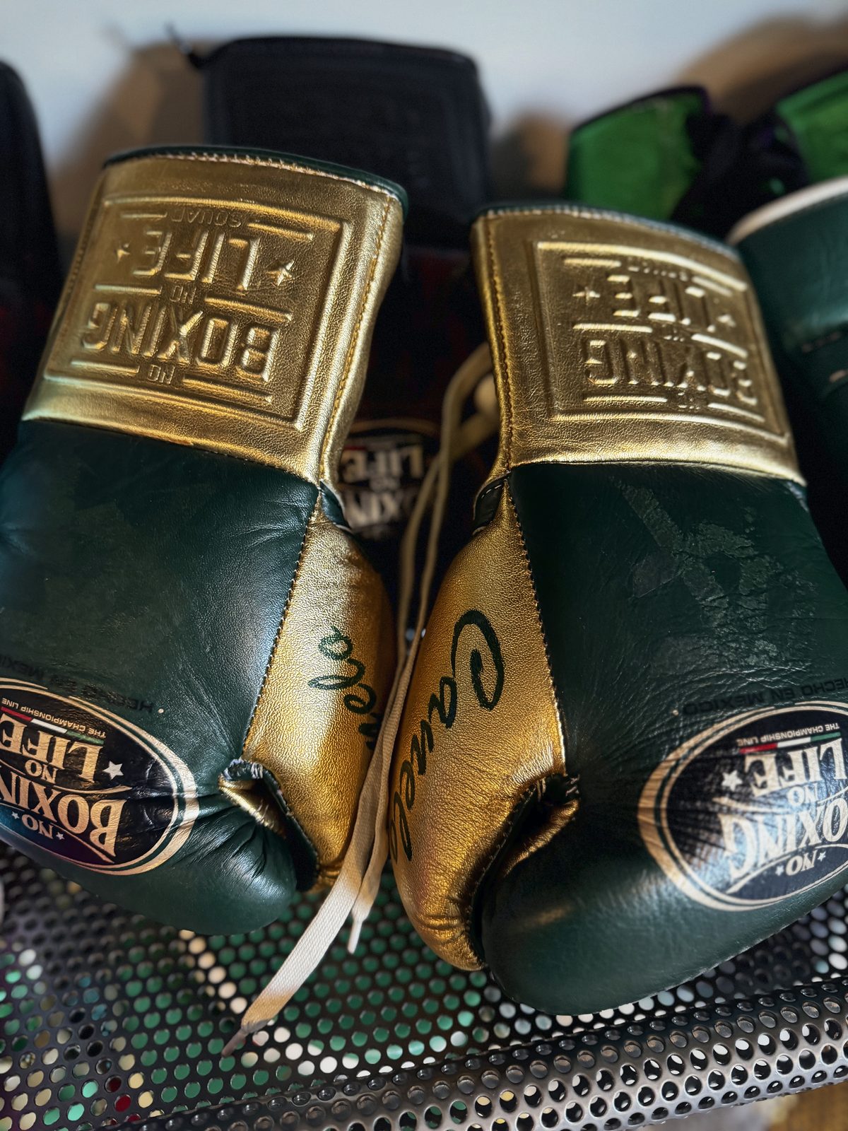 A pair of green and gold No Boxing No Life gloves signed by Canelo